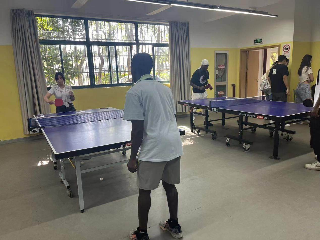 International Students Learning the Proper Serve Action in Table Tennis