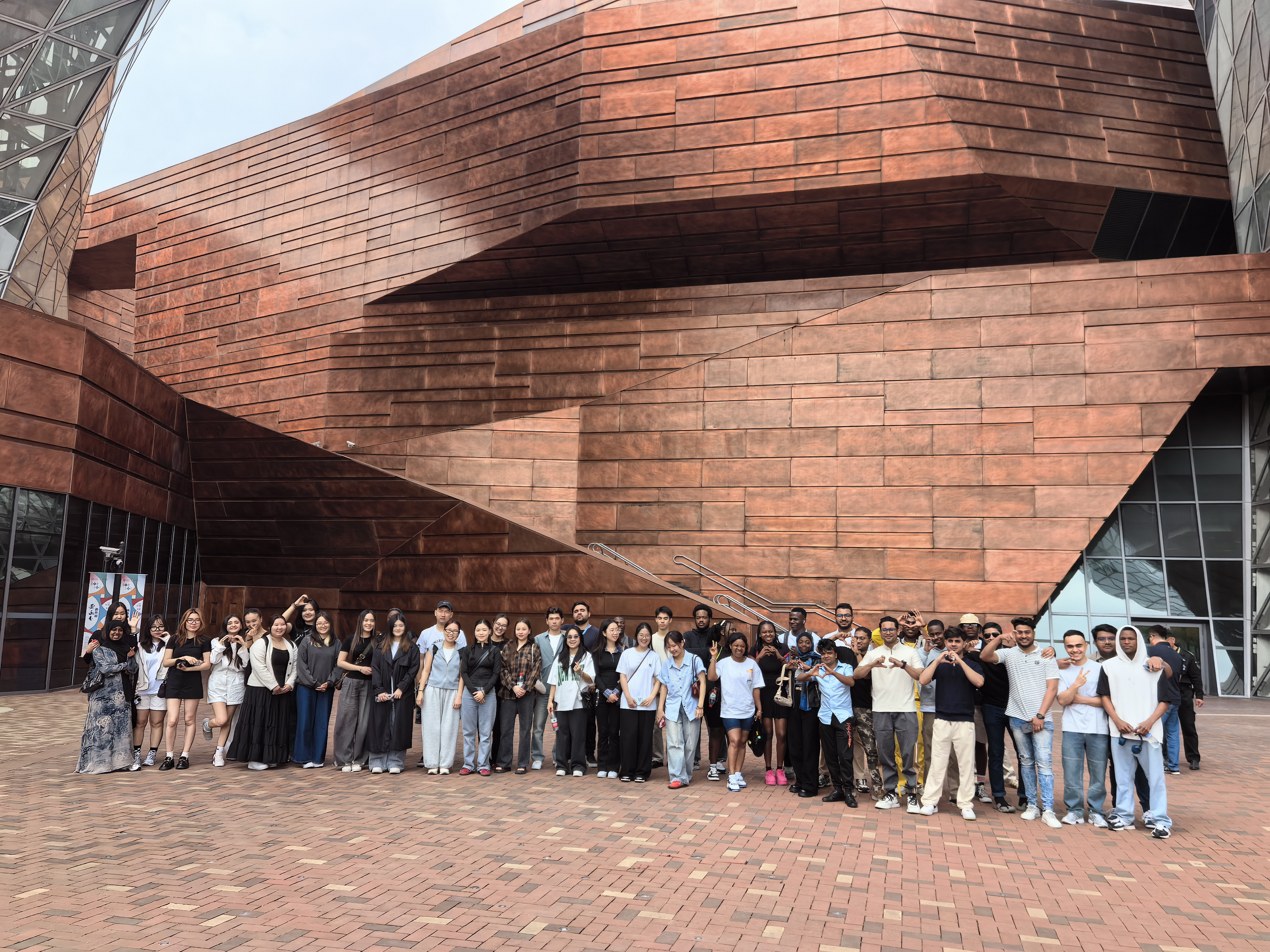 Photo: International students posing for a group photo in front of the Shanghai Expo