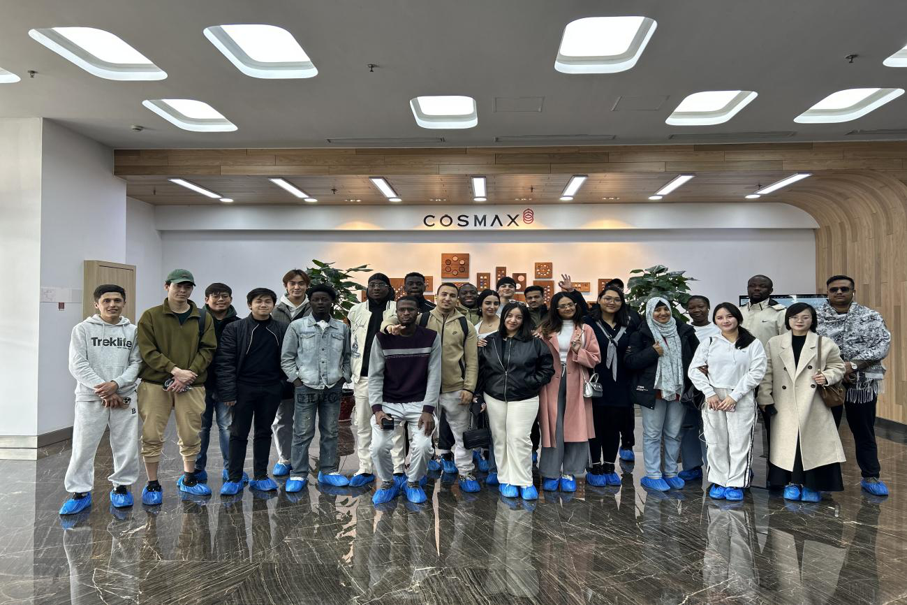 Photo: International students taking a group photo during a company visit