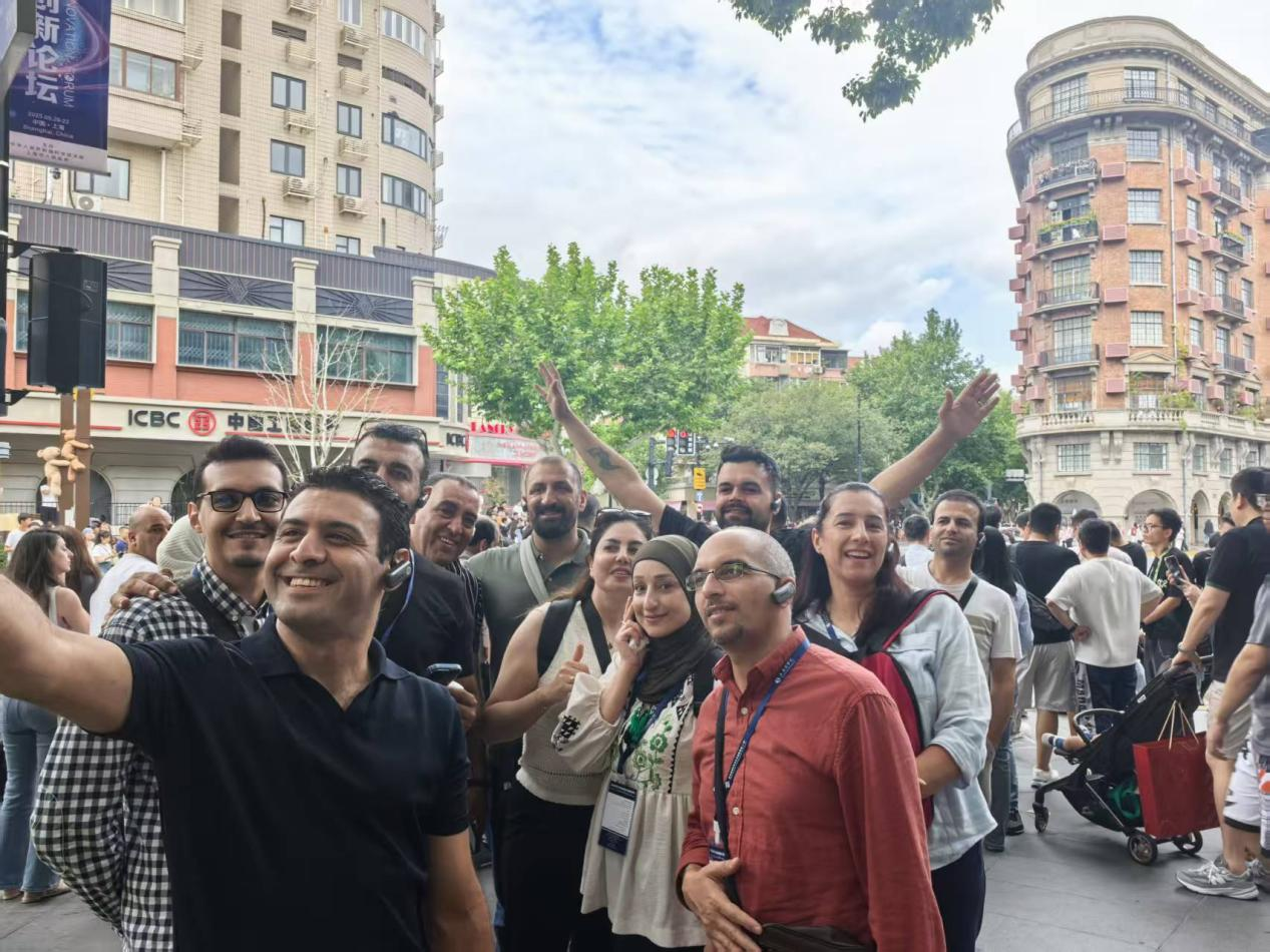 Trainees taking a selfie in front of the Wukang Building
